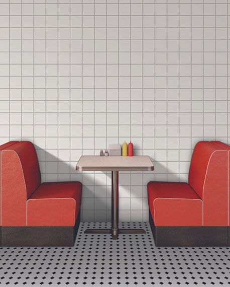 Retro restaurant with red booth & metal table, white & black dot floor tile, white square wall tile.