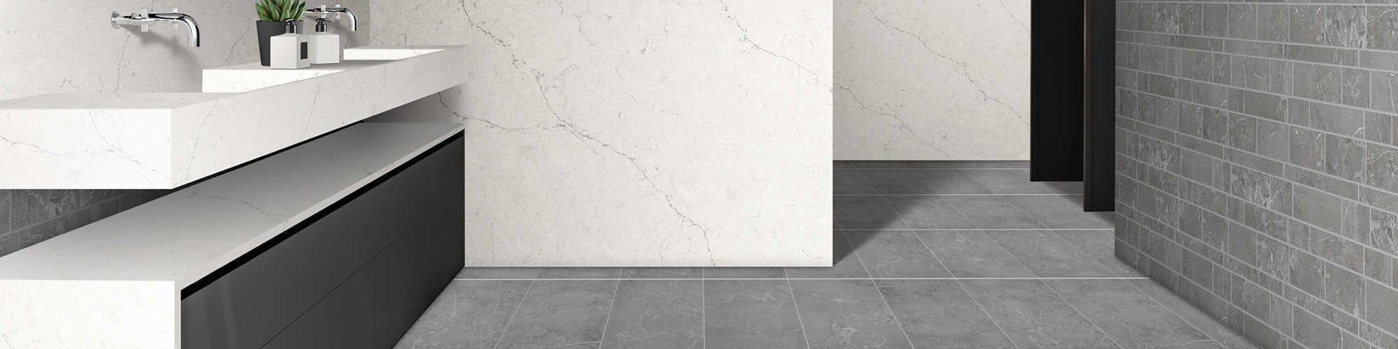 Bathroom vanity with white quartz countertop with gray veining, double sink, gray tile backsplash, white quartz slab seamless wall, gray concrete look floor tile.