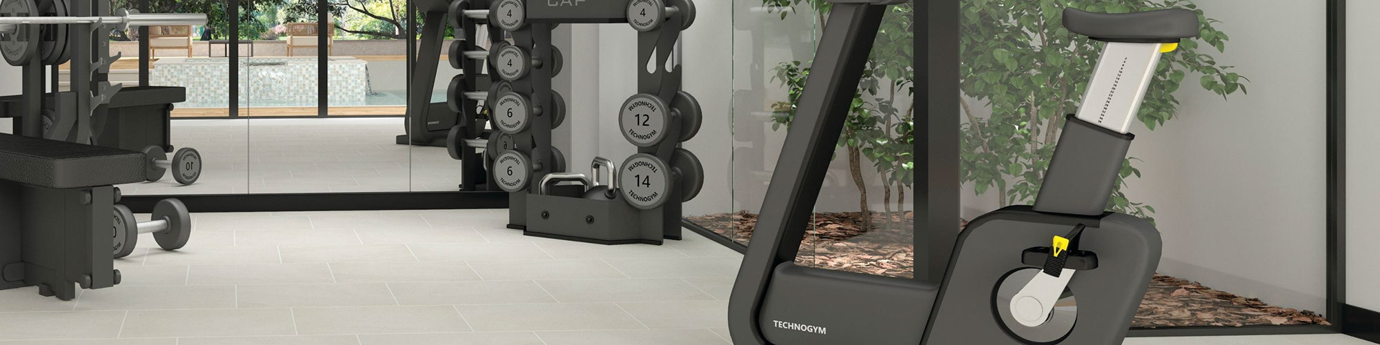 Home gym with cycling machine, free weights, mirrored wall, and off-white floor tile that looks like stone.