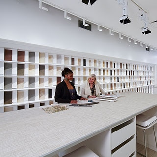 Two women looking at tile samples in the Daltile San Francisco showroom.