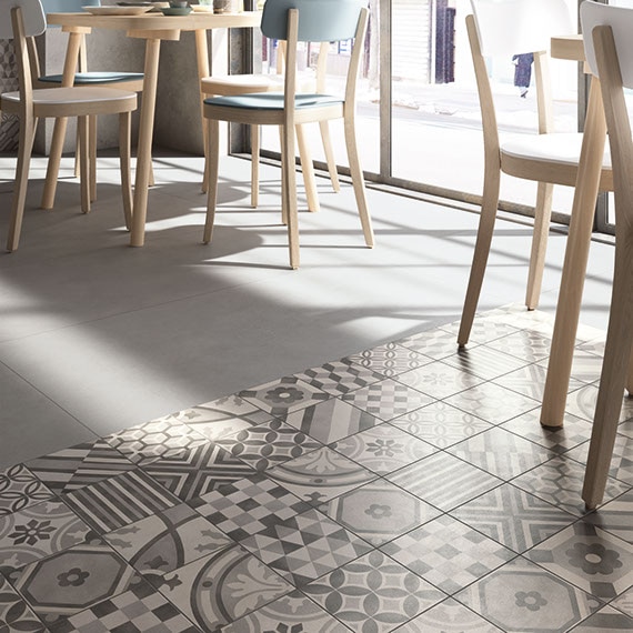 Bistro style restaurant with gray and white encaustic tile rug floor
