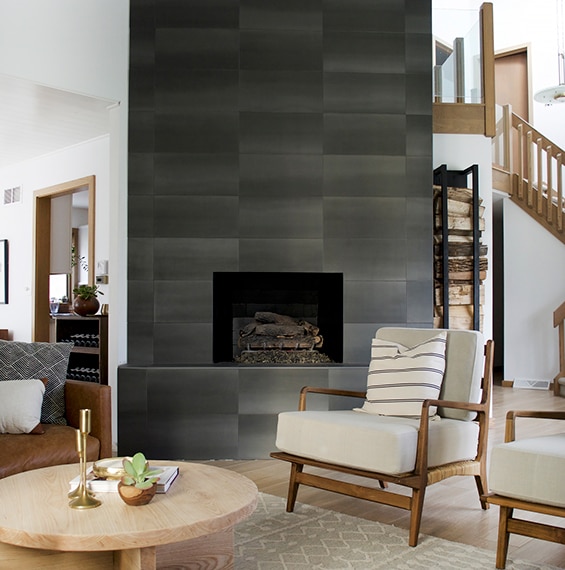 Fireplace in the living room with dark stone look rectangular tiles