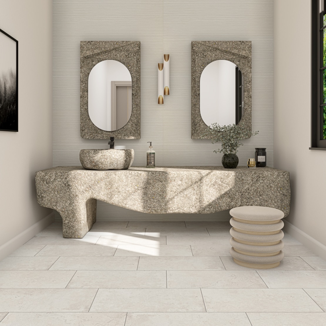 Residential bathroom with countertop craved from stone, monochromatic floors and matching pedestal.