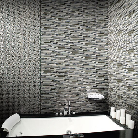 Gray glass mosaic tile walls in a modern bathroom with a contemporary spa bathtub