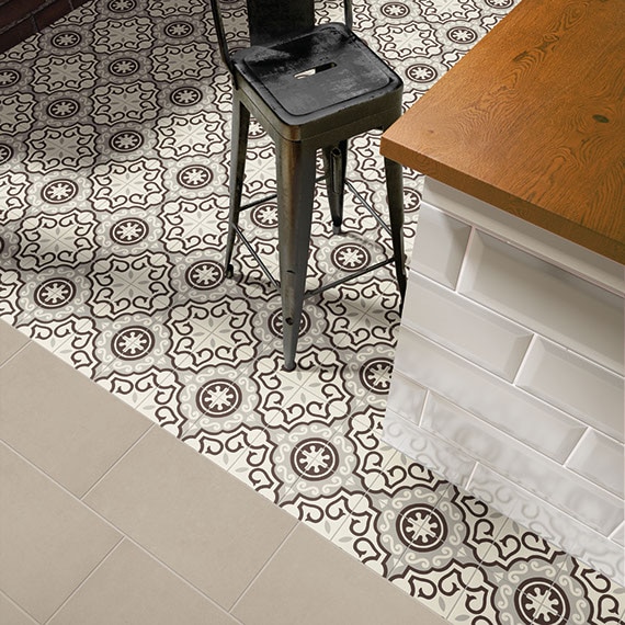 Bird's eye view of kitchen island with encaustic tile in black and gray curvy graphic