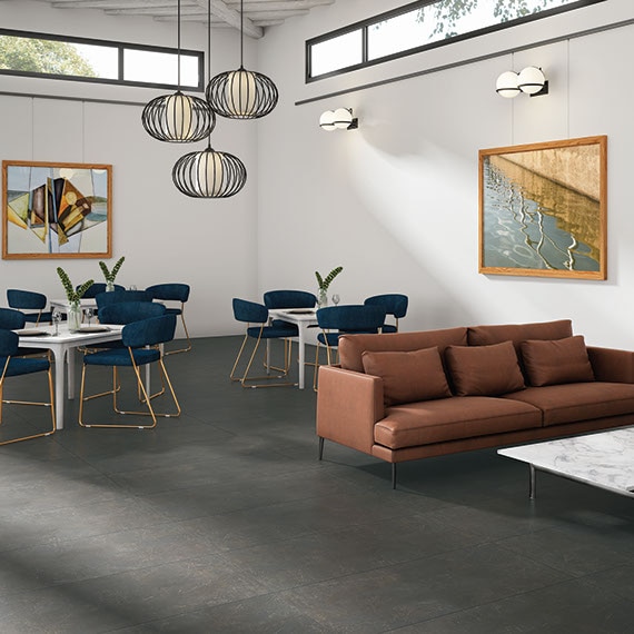 Industrial style living room with monochromatic tile on the floor and modern furnishings