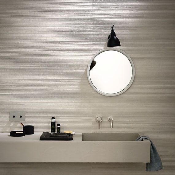 Close up of bathroom vanity with glass tile backsplash in metallic color