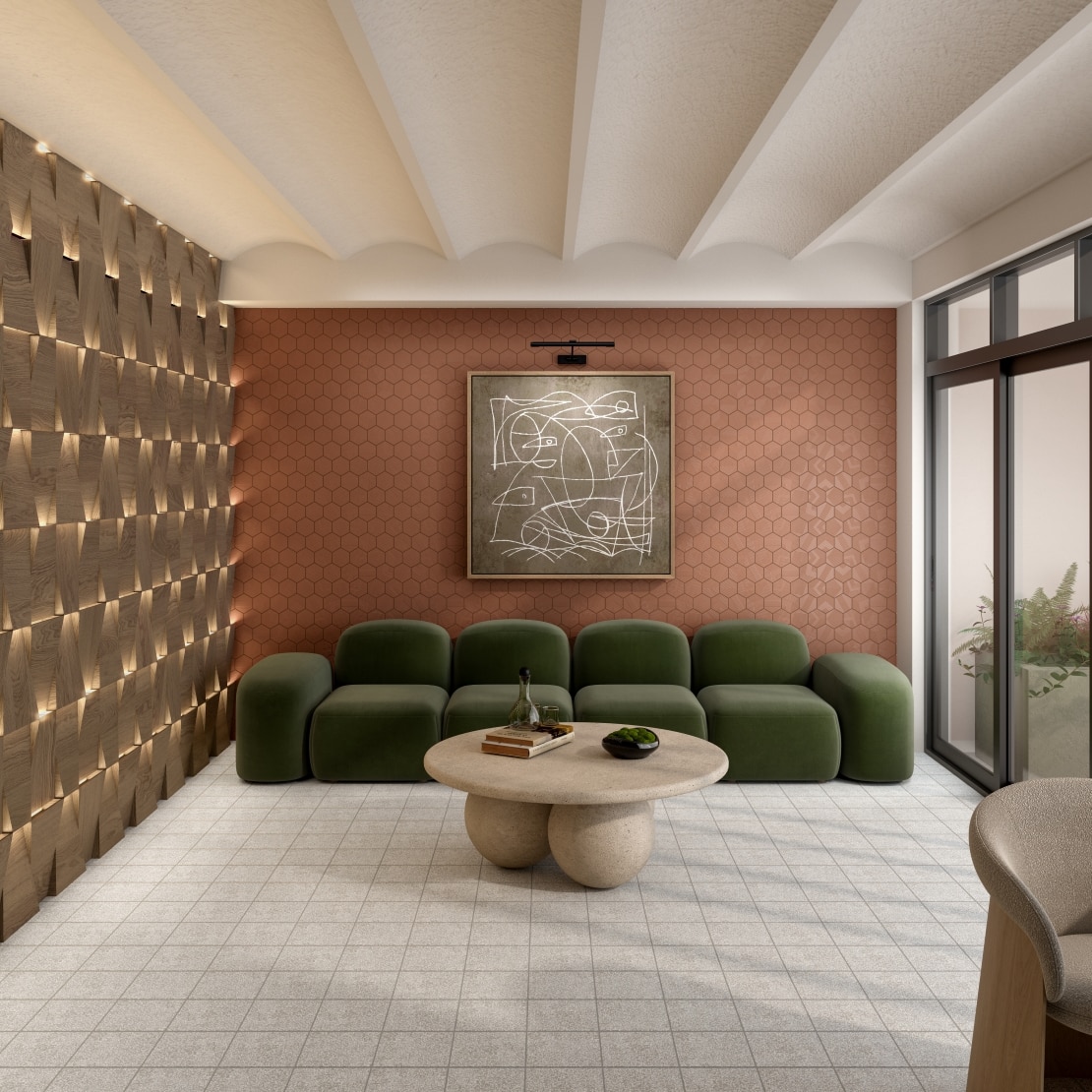 Cozy lounge area with a green modular couch, terracotta wall, golden accent wall and a stone coffee table.