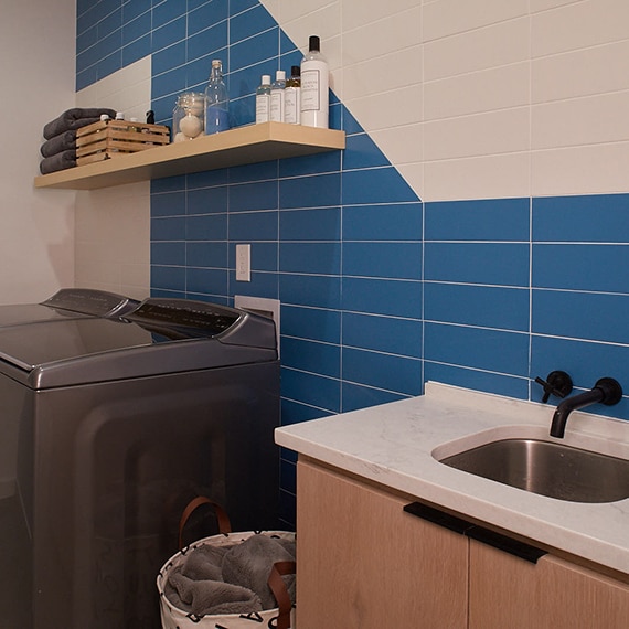 Laundry room with blue and white rectangular tile on the wall