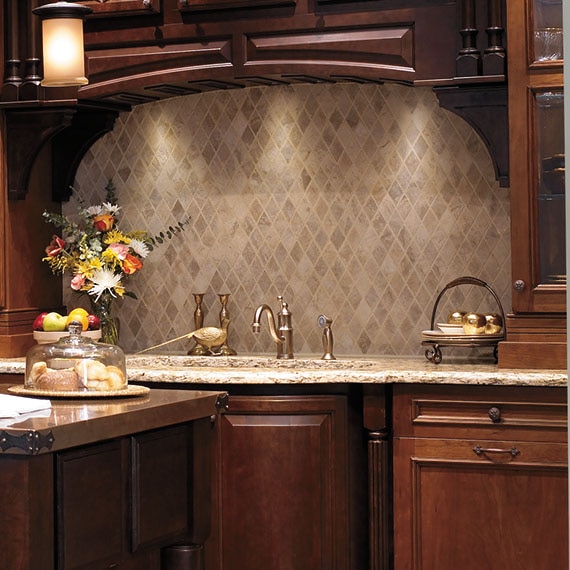 Traditional kitchen with dark wood cabinets and tan diamond pattern mosaic stone tile over the sink