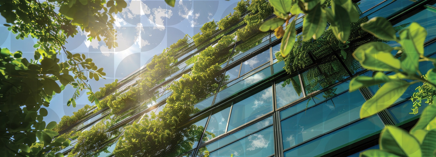 Glass building with green vines and leaves on the side.