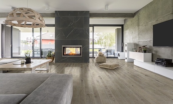 Warm and cozy earth tone lobby with a rustic brick fireplace and traditional wood look floors