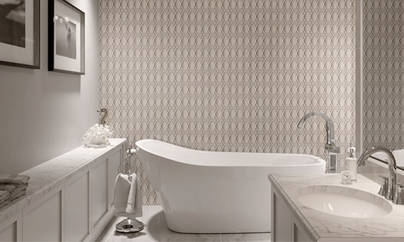 Modern bathroom with pattern wall backsplash behind an elegant bathtub